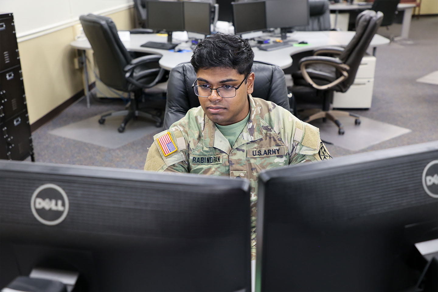 Richard Rabindran in front of two computer monitors