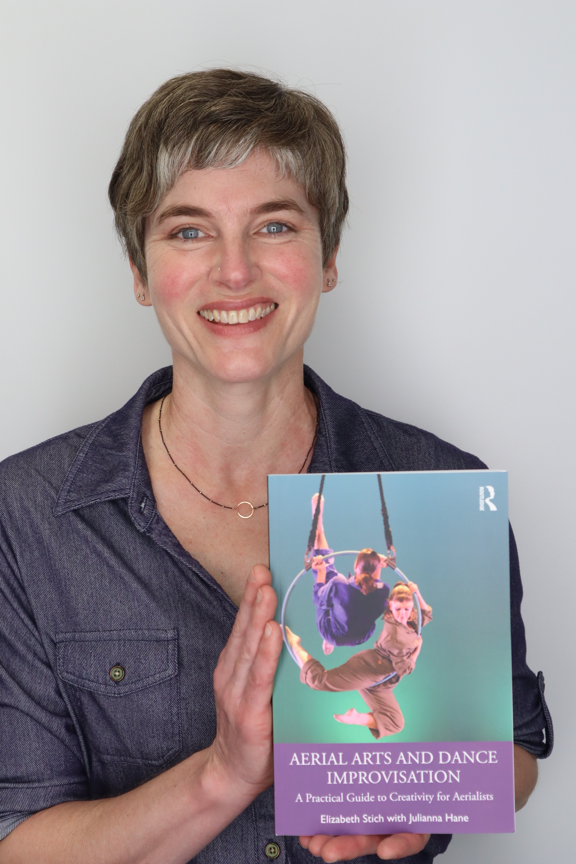 Elizabeth Stich holding up a brochure