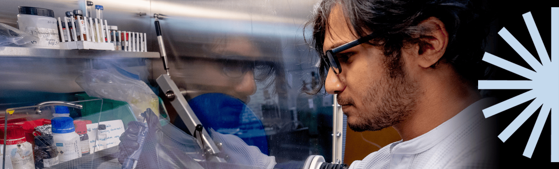 Student in a lab with the Franklin spark logo on the right