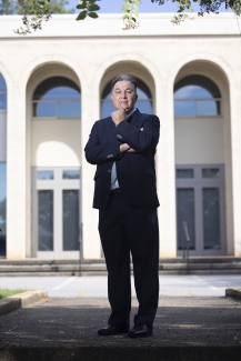 photo of man in front of building, day