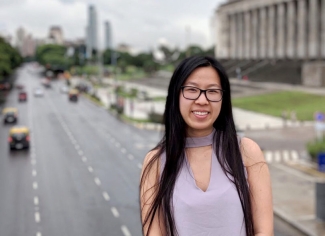 photo of woman outdoors on bridge over highway