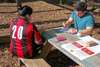 man and woman at table outdoors