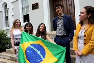 photo of five people with Brazil flag