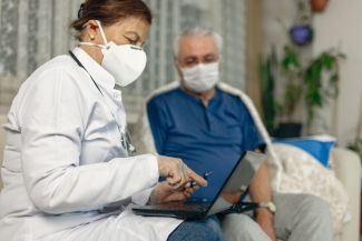 photo of masked nurse with masked patient