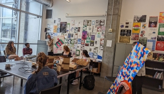 photo of people in discussion space, with images, notes and table