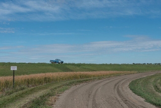 truck in a field, with sky