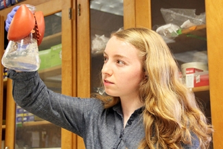 woman in lab with beaker