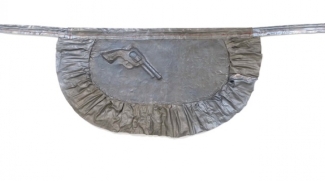 metal sculpture of apron with pistol