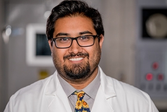 photo of man in lab coat and tie