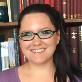 photo of woman, bookshelves in background