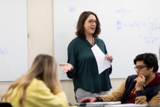 photo of woman speaking to students in classroom