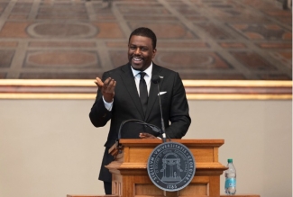 photo of man speaking at podium