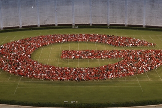 photo of students forming a G on the stadium field