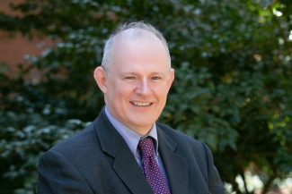 headshot photo of man, outdoors, day