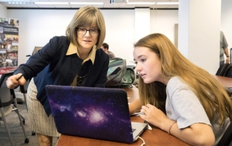 photo of two women with a computer 