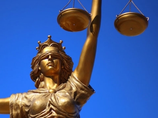 photo of statue of Lady Justice (Goddess), with blue sky