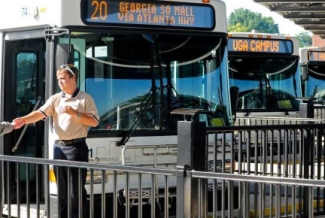 man in front of buses