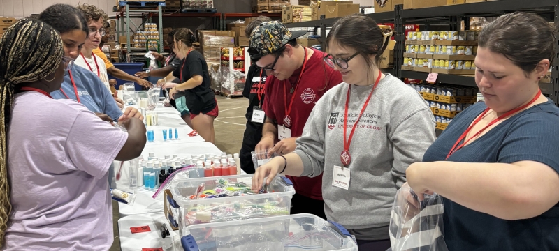 photo of people packing supplies in warehouse