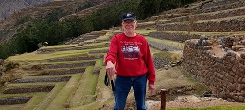 photo of man, ancient terraces in background, day