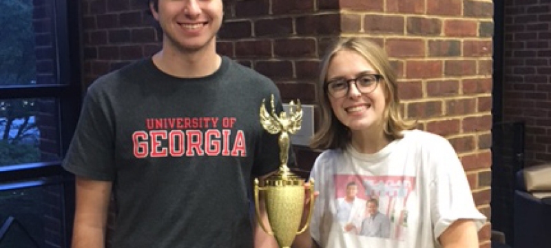 man and woman with trophy
