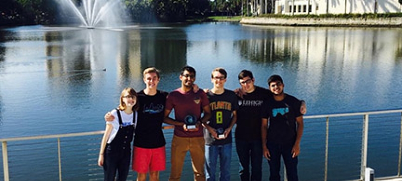six people in front of water, photo
