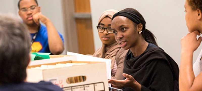 photo of people with file box in discussion