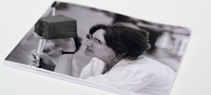 photo of a photo of woman holding pinhole camera