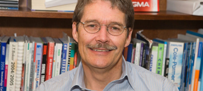 photo of man with bookshelves
