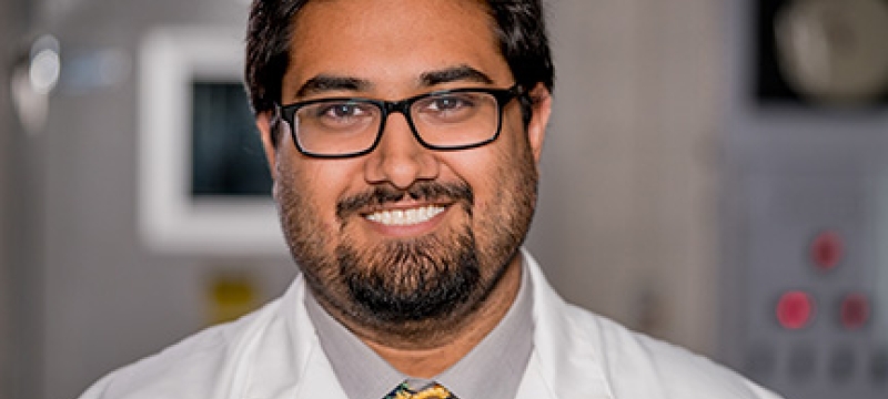 photo of man in lab coat and tie