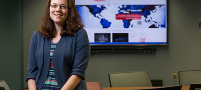 woman with flat screen TV in background, classroom