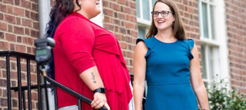 two women on stairs outside of Old College