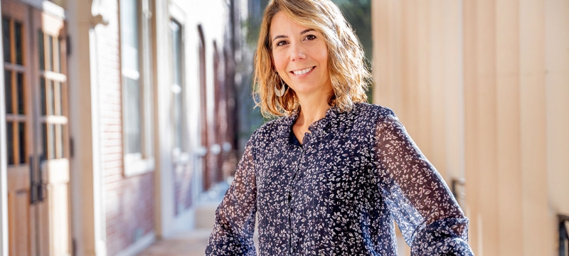 Photo of woman on building porch, day