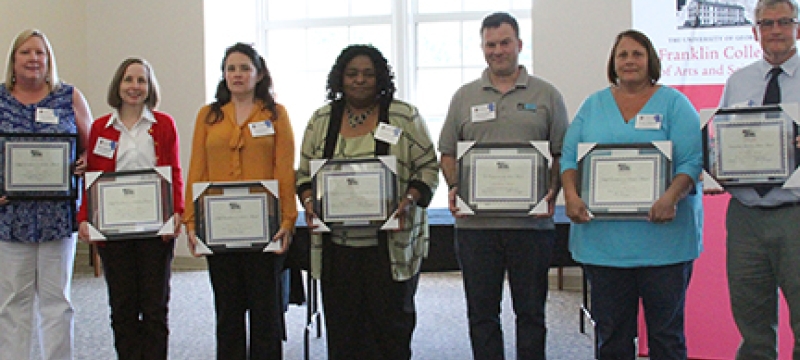 7 people with award plaques
