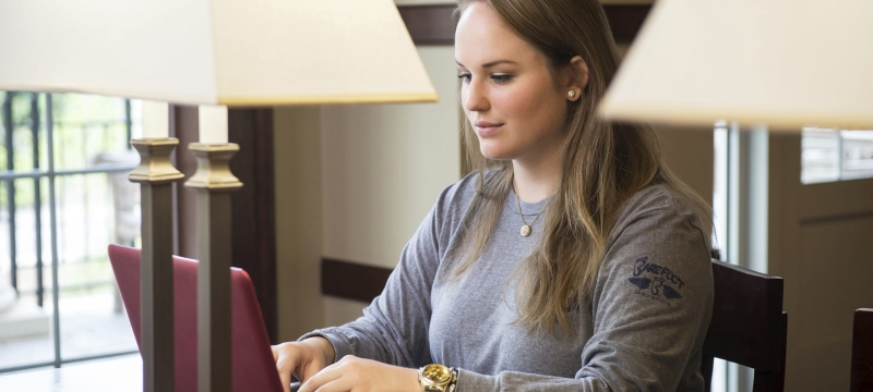 photo of woman typing on laptop computer
