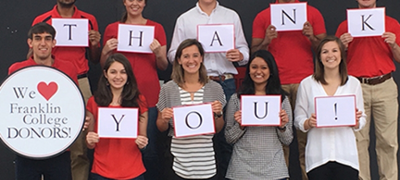 students with thank you signs