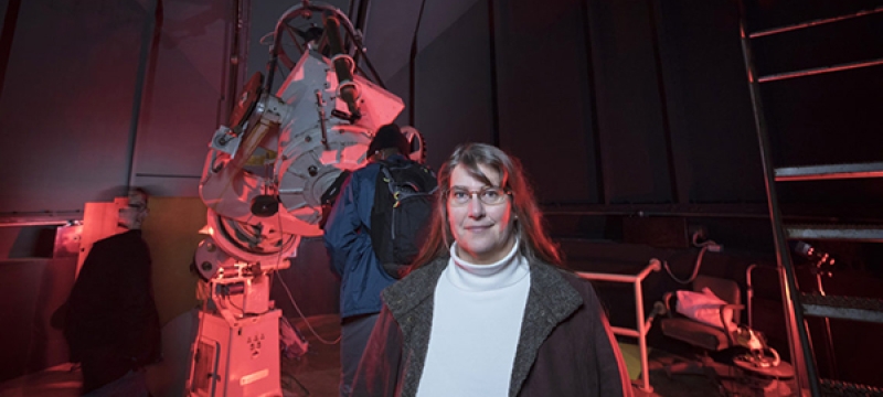 woman with telescope in the background