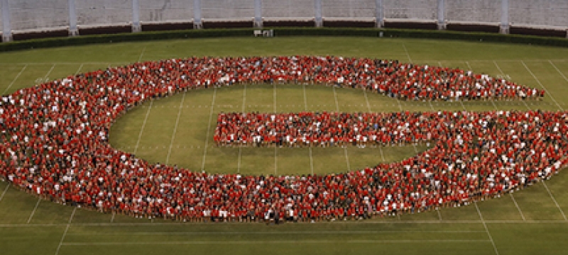 photo of students forming a G on the stadium field