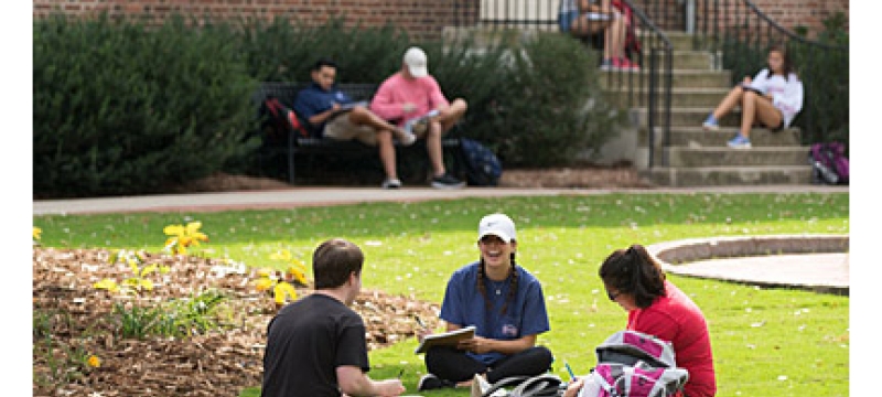 students on the lawn in front of old college