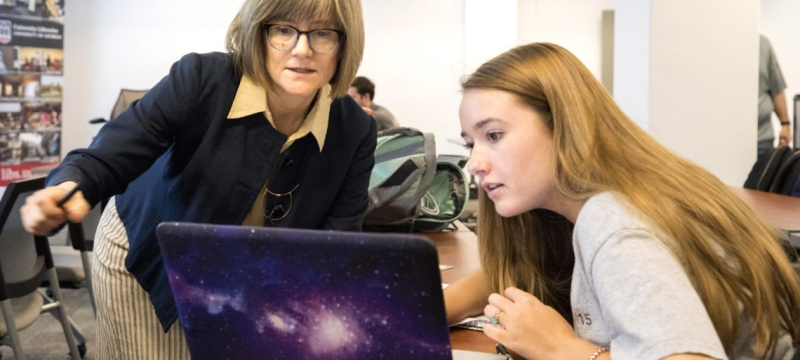 photo of two women with a computer 