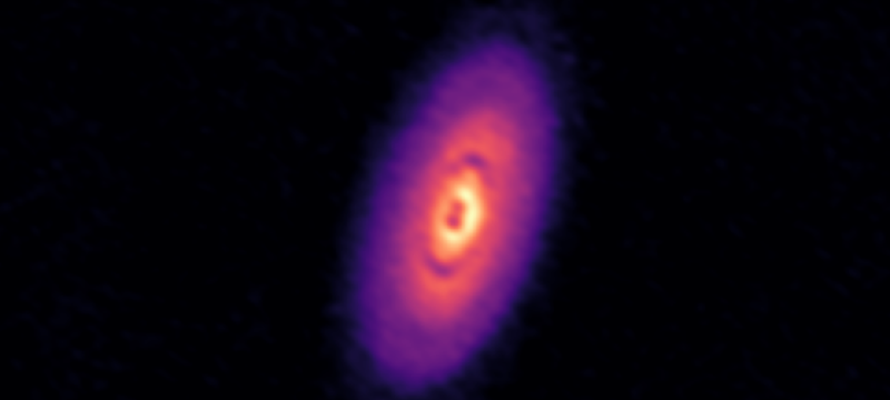 telescopes image of purple, organ and yellow disk in space