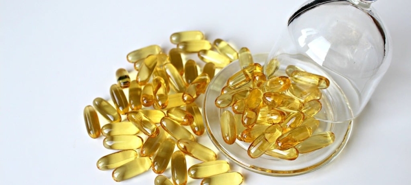 photo of yellow capsules and glass plate, with cover