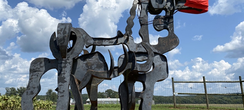 photo of iron sculpture, blue sky