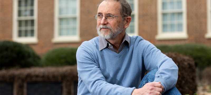 photo of man, with building in background