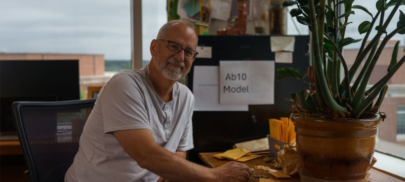 photo of man at desk with corn kernels