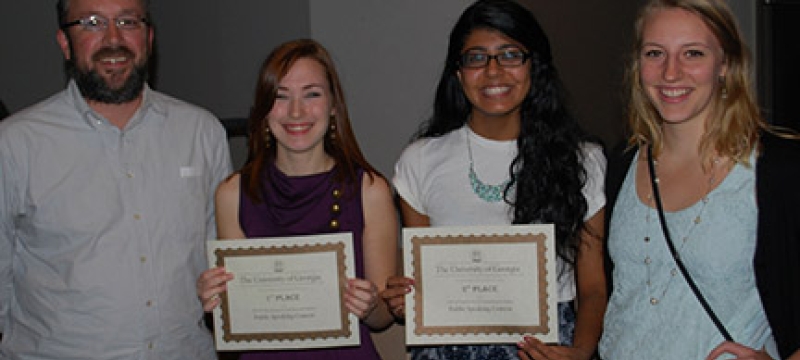 four people, two with certificates, photo