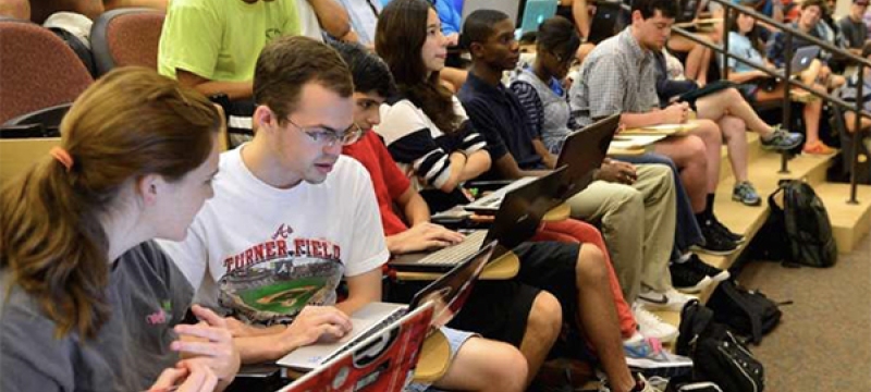 photo of students auditorium classroom with laptops