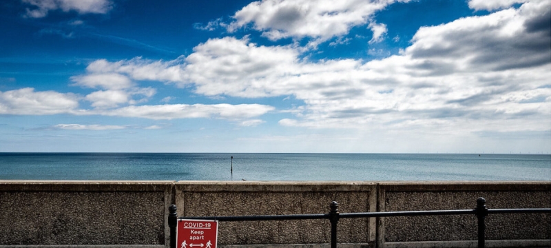 photo of open water, wall and red sign