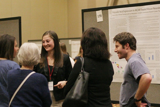 students talking near a poster