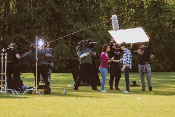 photo of people working on film set, outdoors, day