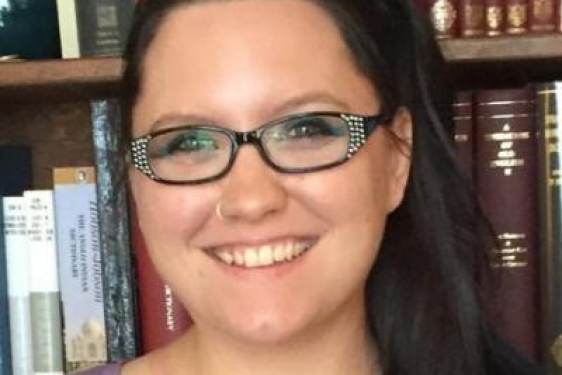 photo of woman, bookshelves in background